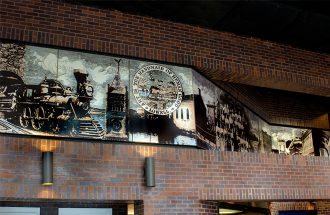 Pat Conant - The Charles A Gallagher Mural is a 5' x 55' mural porcelain enamel on steel and at the Charles A. Gallagher Terminal in Lowell, MA. Select image to view larger.
